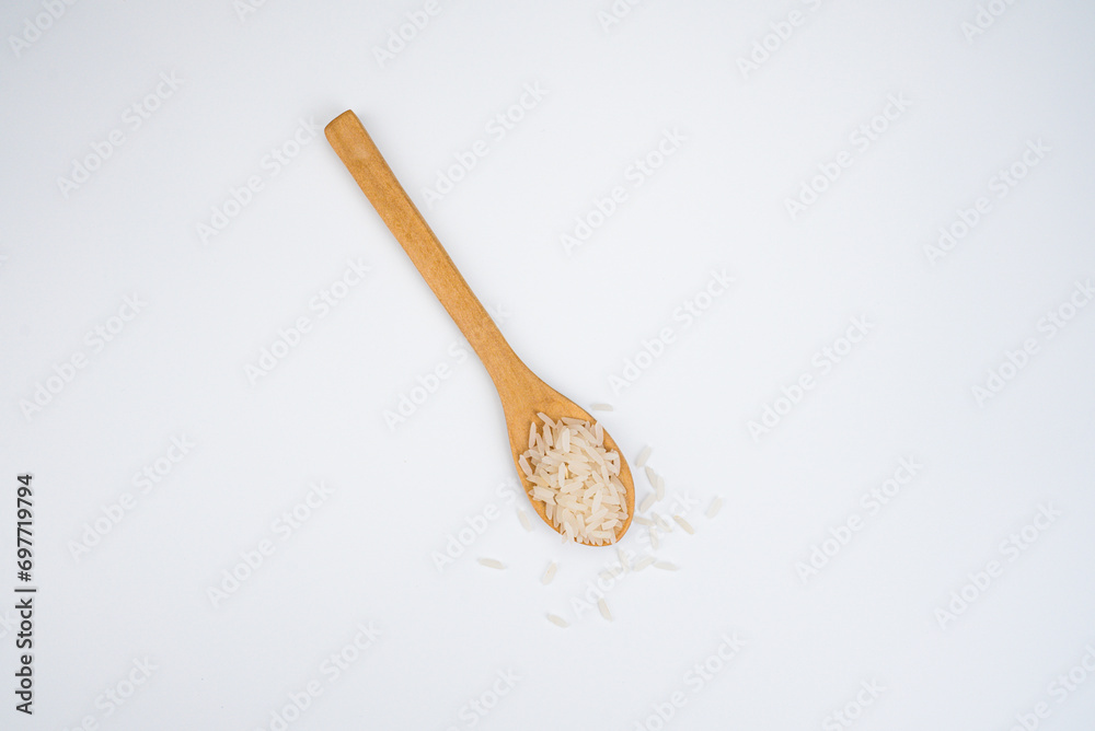 rice in wood spoon isolated on white background rice in wood spoon isolated on white background