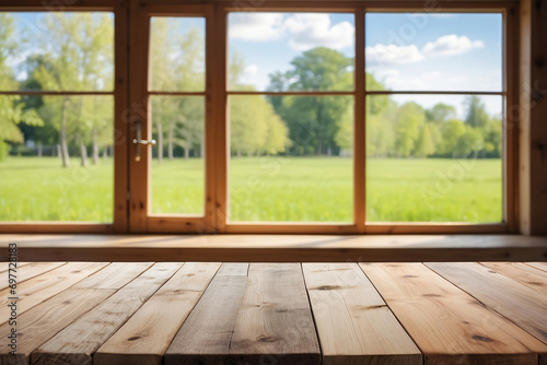 The empty wooden table with a blurred kitchen window in the background