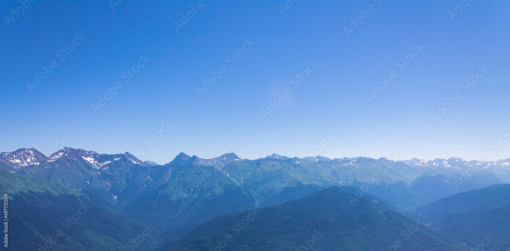 Beautiful mountain landscape with a green picturesque mountain range against a blue sky