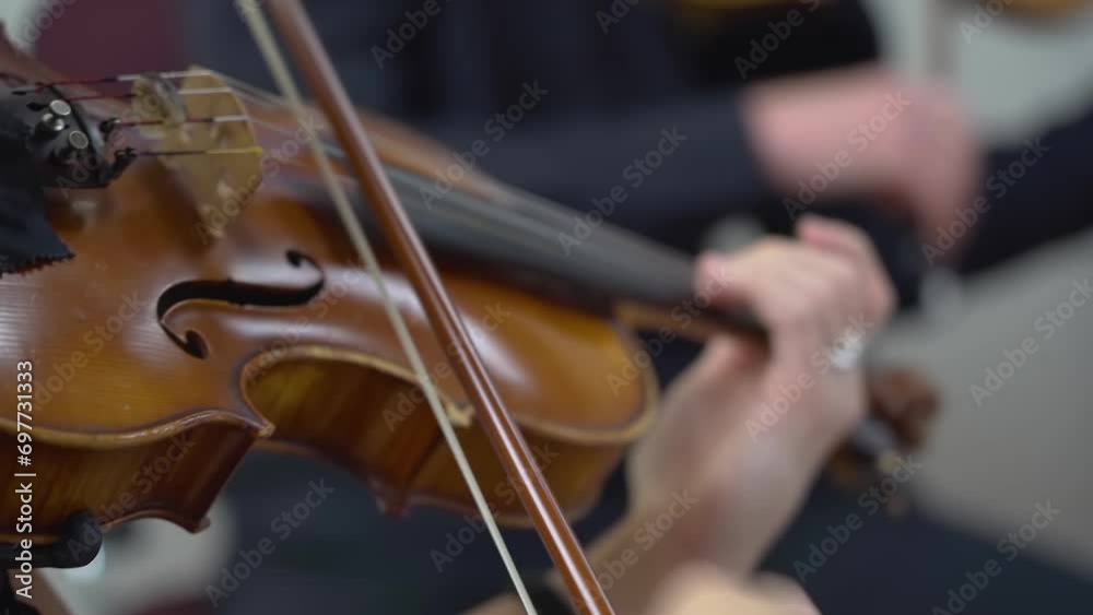 Female violinist playing violin in musical performance. Women playing classical music at a concert