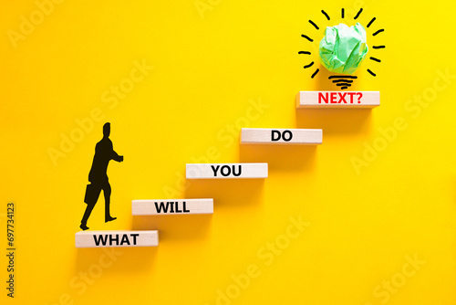 What will you do next symbol. Concept words What will you do next on wooden blocks. Beautiful yellow table yellow background. Businessman icon. Business, what will you do next concept. Copy space.