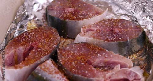 pieces of sea fish during cooking, raw yellow-tailed fish during cutting for cooking photo