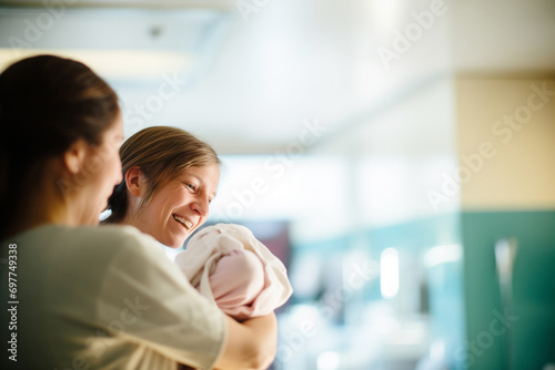 Mother with Newborn and Nurse in Hospital