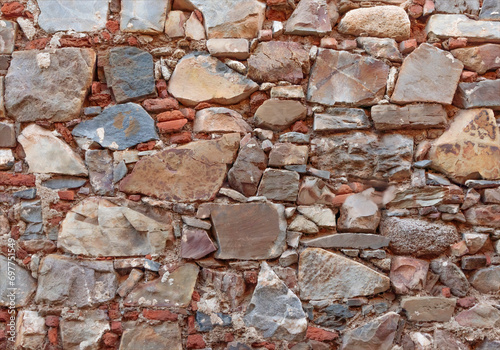 Background of ancient bricks and stones in a wall
