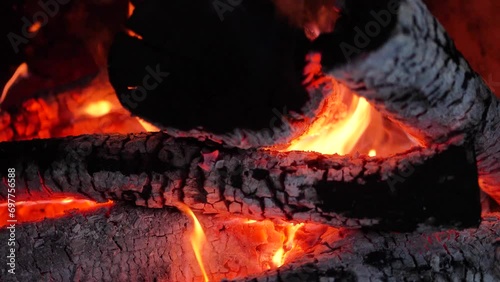 Stone fireplace with burning logs and smoke photo
