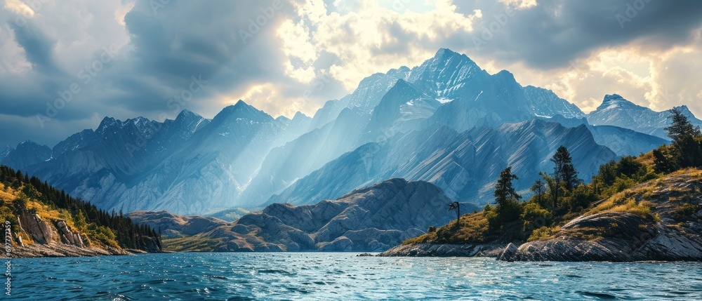 Obraz na płótnie mountains over the lake with rays of the sun landscape w salonie