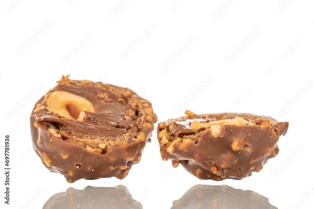 Two halves of a chocolate candy with a nut, macro, isolated on a white background. Two halves of a chocolate candy with a nut, macro, isolated on a white background.