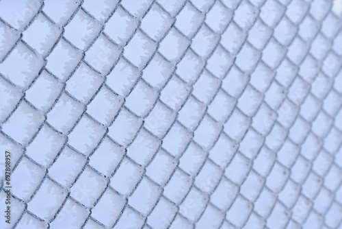 Mesh of chain link covered with frost after severe frost. Macro photography.