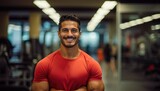 Smiling fit man in a gym representing health and fitness concepts