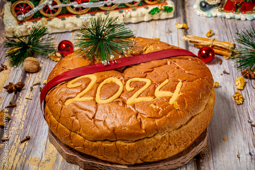 Traditional Greek new years cake, known as vasilopita, for 2023 and Christmas ornaments