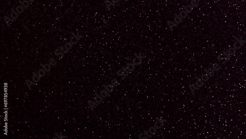 Fast moving side-to-side dark red sparkly background space-like stars constantly glistening filling the frame photo