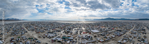 People camping in a desert during a heavy storm. Aerial shot of the camp city from above. photo
