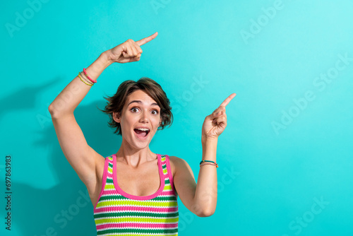 Portrait of excited pretty lady direct fingers showing ad ads adv empty space novelty sale store prices isolated teal color background