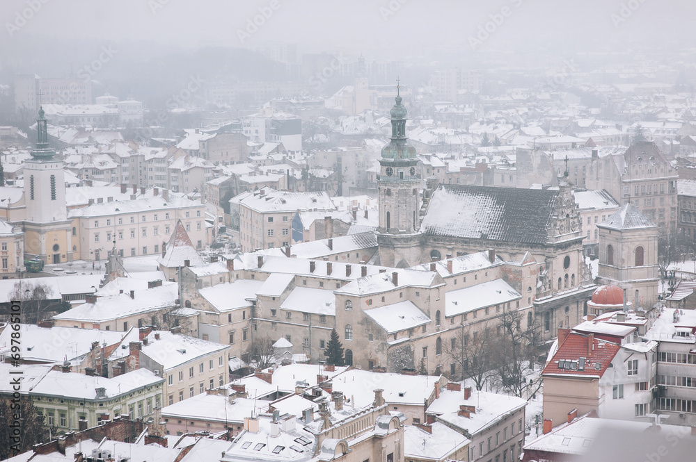 Winter snowy city, top view. Tower of St. Andrew's Church in Lviv, Ukraine.