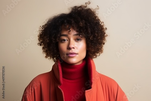 Young african american woman with curly hair wearing a red hoodie