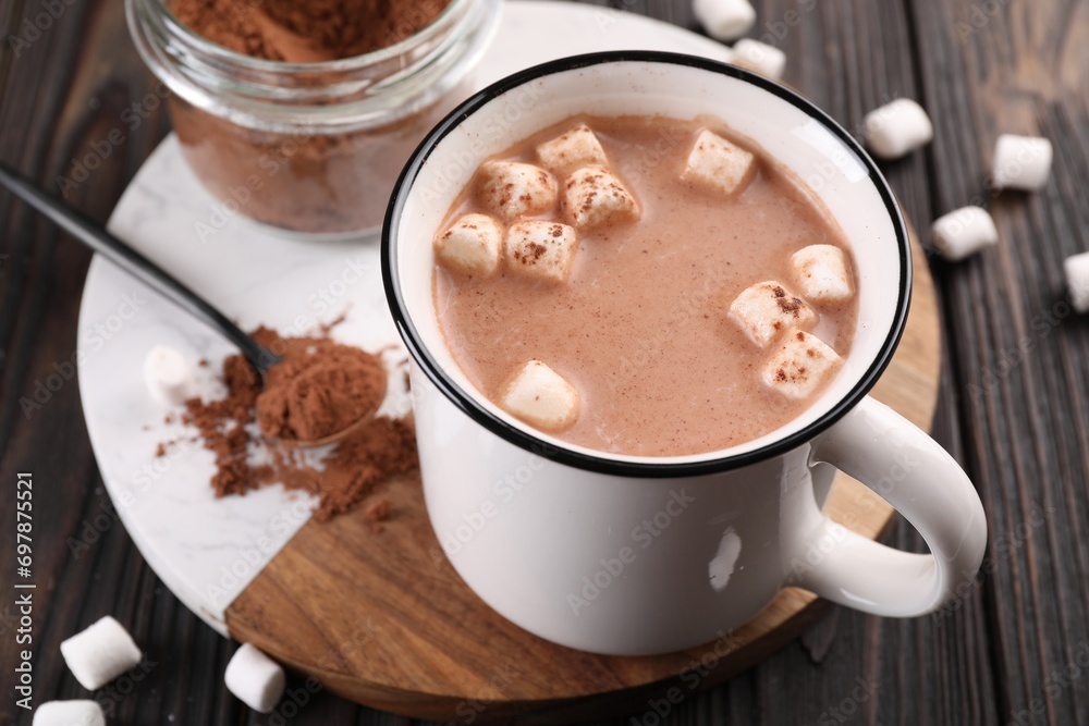 Cup of aromatic hot chocolate with marshmallows and cocoa powder served on table, closeup Cup of aromatic hot chocolate with marshmallows and cocoa powder served on table, closeup