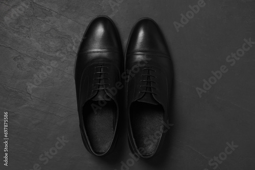 Pair of leather men shoes on grey surface, top view