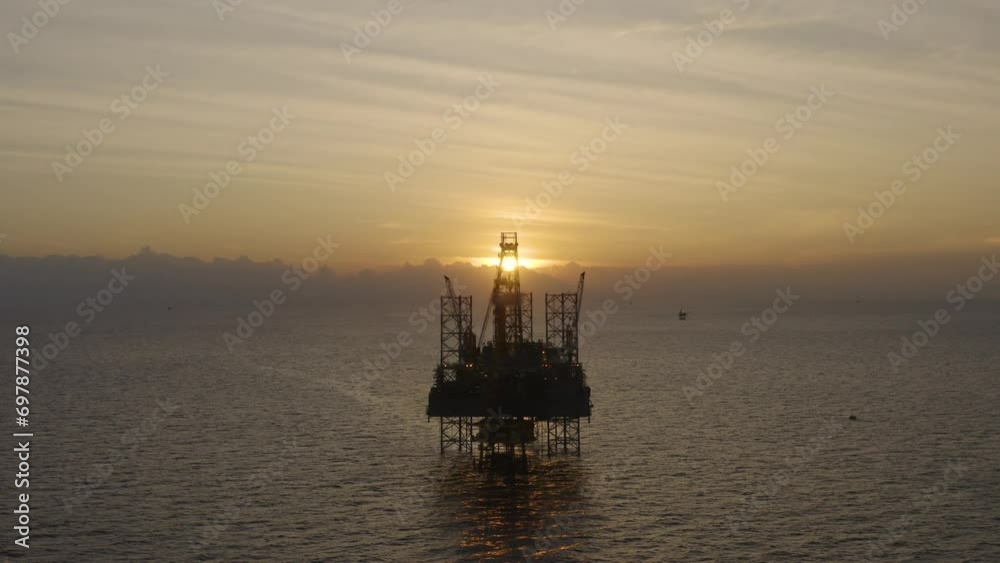 Aerial view of silhouette offshore jack up drilling rig during sunset - oil and gas industry
Aerial view of silhouette offshore jack up drilling rig during sunset - oil and gas industry