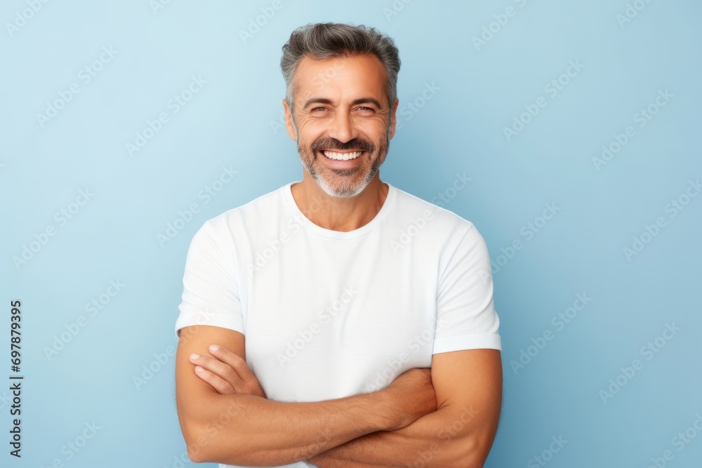 Handsome middle-aged man with white t-shirt on blue background - obrazy, fototapety, plakaty 
