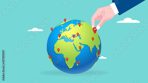 Businessman hand put new branch pin on world map across globe.Global business expansion, open company branches, franchise in new location to cover all continent. growing business worldwide concept