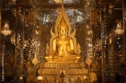 Beautiful Buddha statue contained in glass Viharn in Wat Tha Sung temple one of the famous places in Uthai Thani province of Thailand. © boyloso