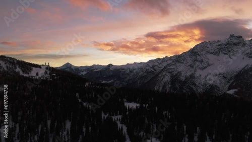 Winter season in Valmalenco of Valtellina at sunset, aerial drone backward view photo