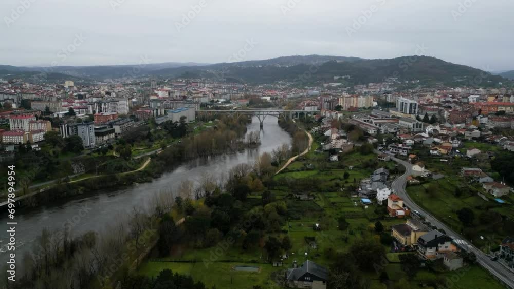 Drone rises along Mino river to establish urban metropolis of Ourense Spain Drone rises along Mino river to establish urban metropolis of Ourense Spain