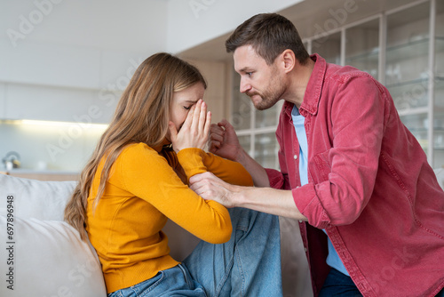 Despotical husband ready to hit, beat terrified helpless wife. Crying woman suffering from domestic violence. Relationship difficulties, gaslighting, conflicts, scandal, marital discord in family life