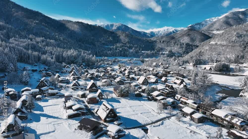 Aerial view of Shirakawago village in Japan in winter, snowy winter wonderland on a sunny frosty day in a mountain valley, Japanese winter tourism