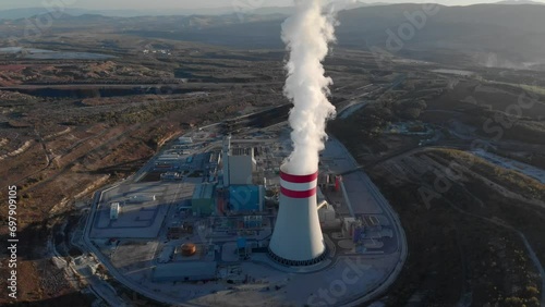 Aerial view Smoke from a coal fired power plant chimney Tilt down Sunset photo