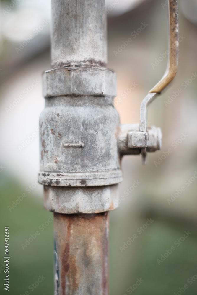The water tap used to regulate the flow of water looks like it has started to rust The water tap used to regulate the flow of water looks like it has started to rust