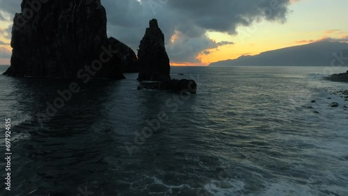 Footage filmed in Madeira Portugal at Ilheus da Ribeira da Janela sea stacks. Filmed at sunrise with incredible landscapes, ocean, cliffs and nature all around. Filmed with a drone in 4k photo