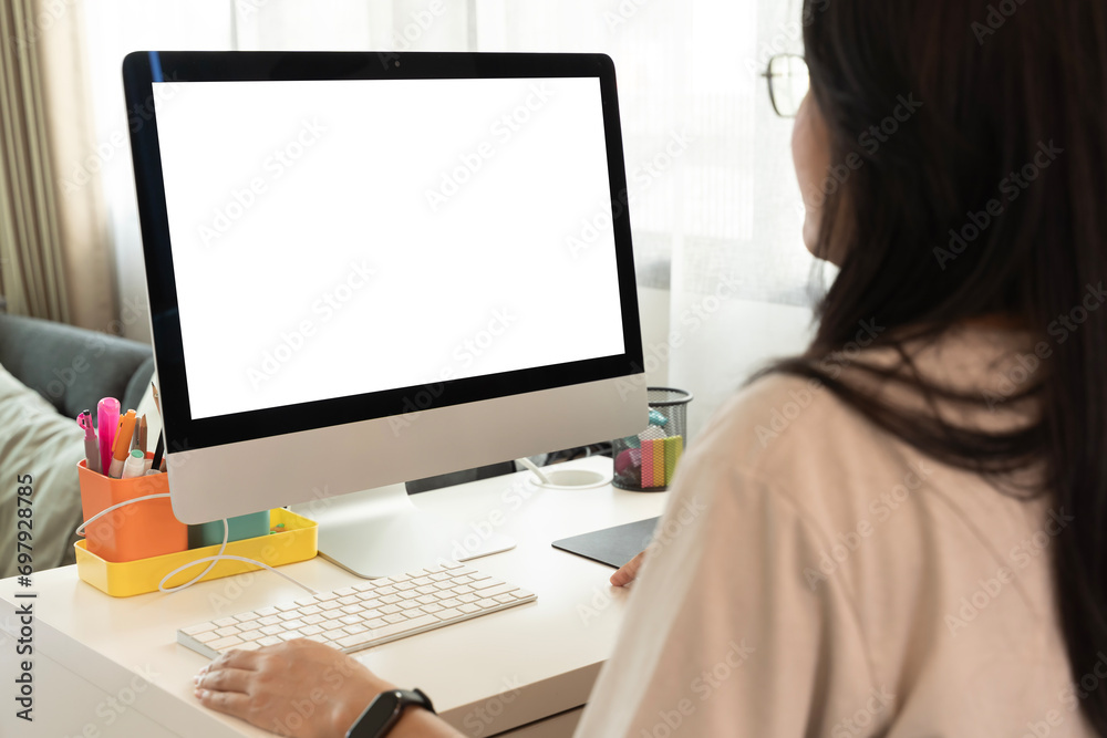 Close up portrait of beautiful business woman in suit working at computer with documents in light office, looking at the monitor. Copy space for advertisement.