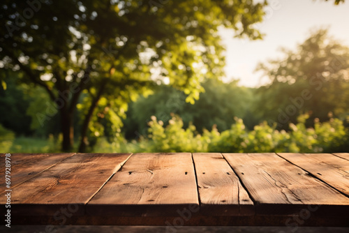 Empty wood table top and blurred garden with bokeh and sunlight. Product and display. Generative ai. © Thodsapol