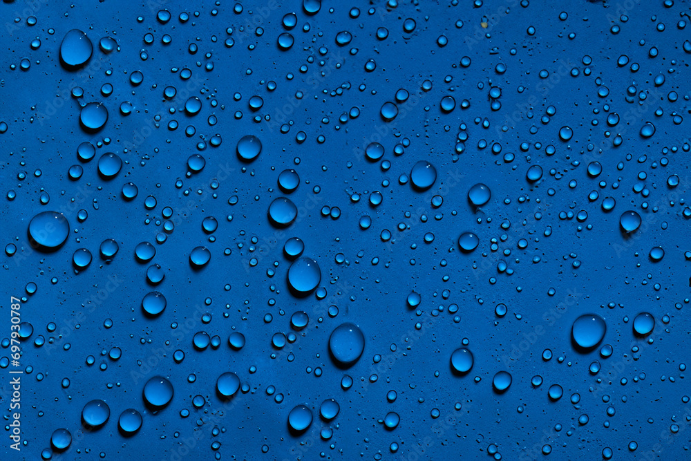 Water droplets on dark blue background