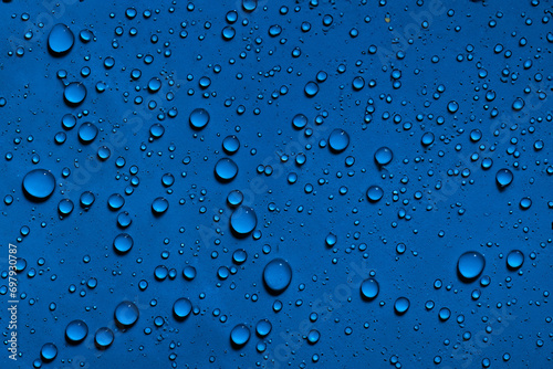 Water droplets on dark blue background