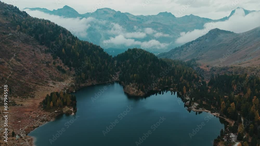 Flying over autumn moody mountain lake Cavloc in Switzerland, Maloja Flying over autumn moody mountain lake Cavloc in Switzerland, Maloja