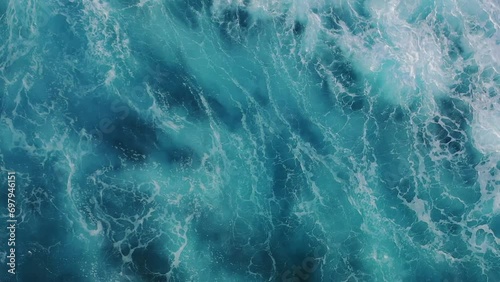 Aerial view of waves crashing in the sea photo