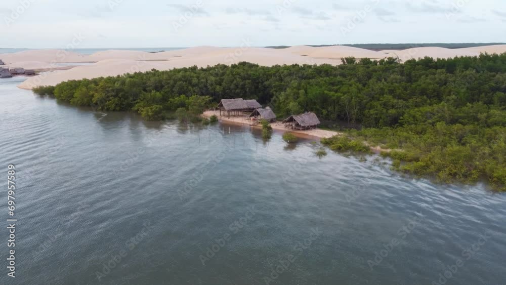 Brazilian fisher house in the jungle next to a sand dune at the delta Brazilian fisher house in the jungle next to a sand dune at the delta