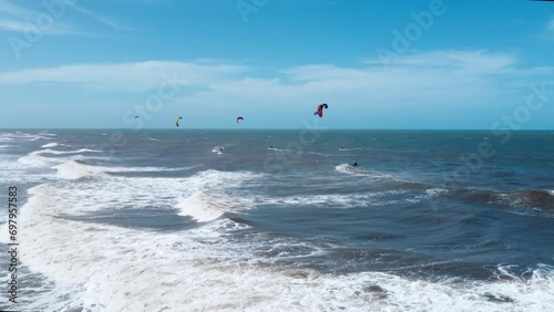 group of kitesurfer riding in the wavy ocean