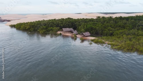 Brazilian fisher house in the jungle next to a sand dune at the delta photo