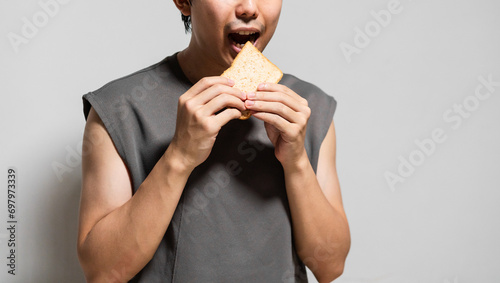 close up of man eating a slice of bread.  photo