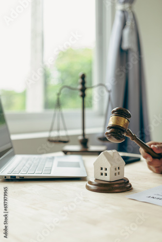 Laws regarding real estate transactions Real estate auction concept division of property real estate Legal system, judge, hammer and house model on wooden table Close-up pictures
