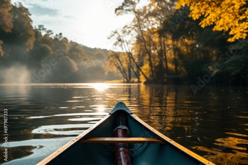 Tranquil canoe trip on a calm river with golden sunlight filtering through autumn trees. © robertuzhbt89