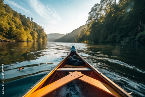 Canoeing adventure through a serene river with forested hills under a clear sky.