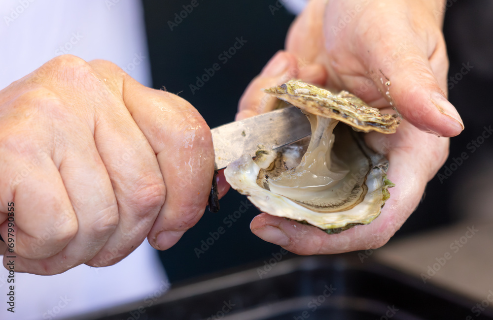 Opening an oyster with a knife