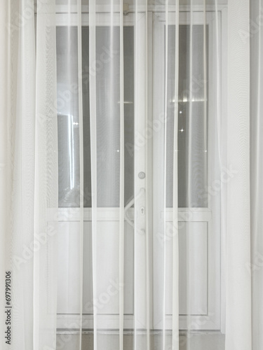 White curtains by the window as an abstract background. Texture