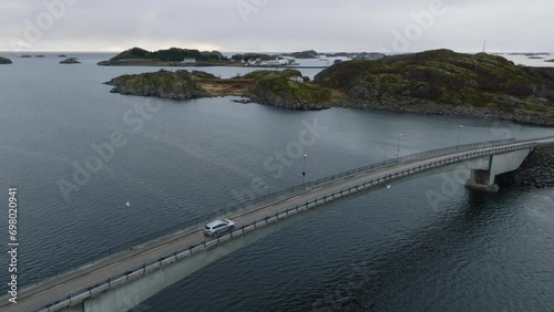 aerial view of a car moving on henningsvaer bridge on lofoten islands in norway