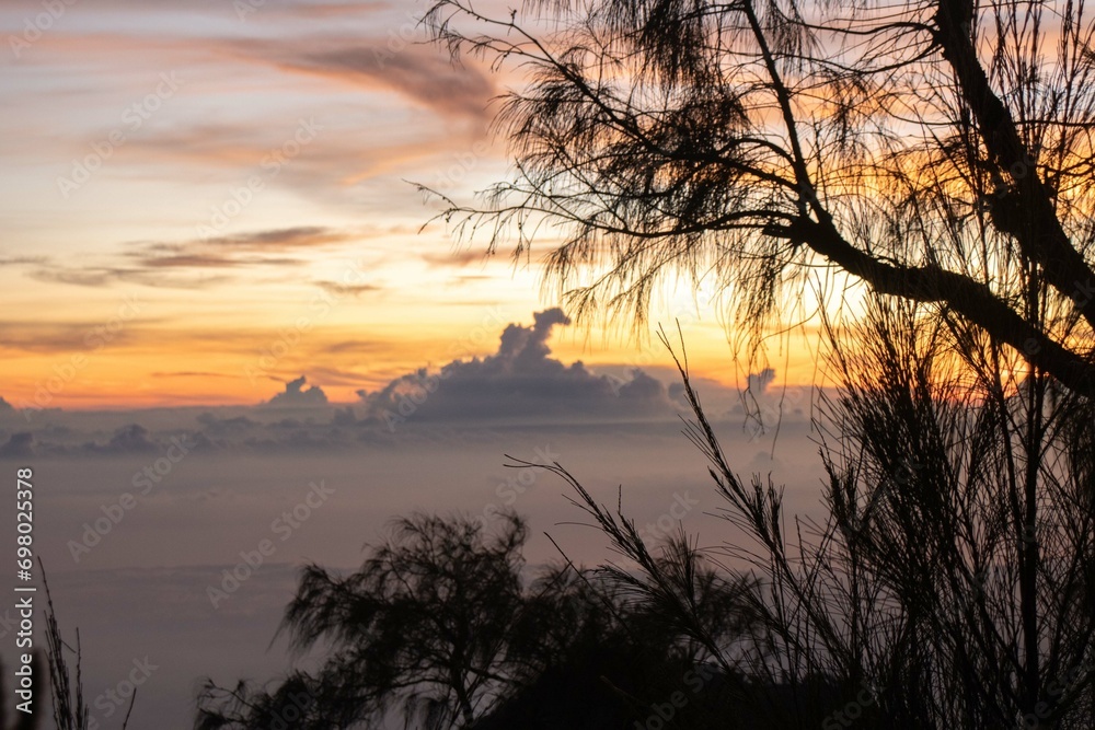 the beauty of the sunrise from the top of the mountain is like a hidden paradise behind the jungle.