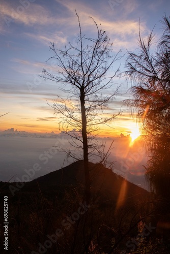the beauty of the sunrise from the top of the mountain is like a hidden paradise behind the jungle.
